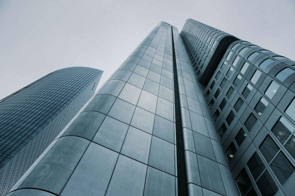 Looking up at the top of a city skyscraper.