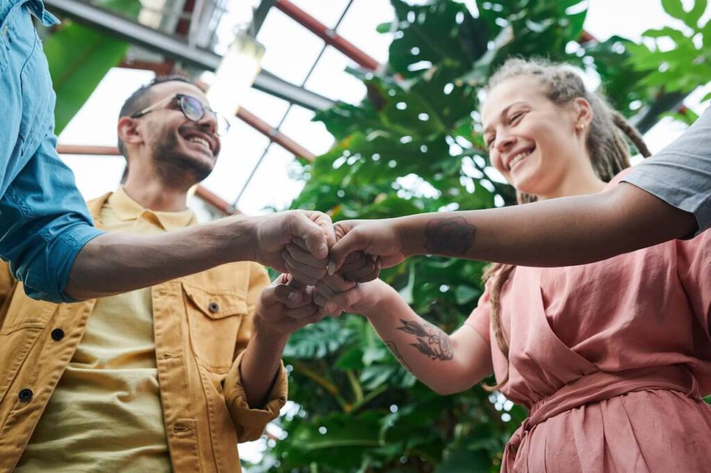 Happy staff fist-pump, smiles teamwork.