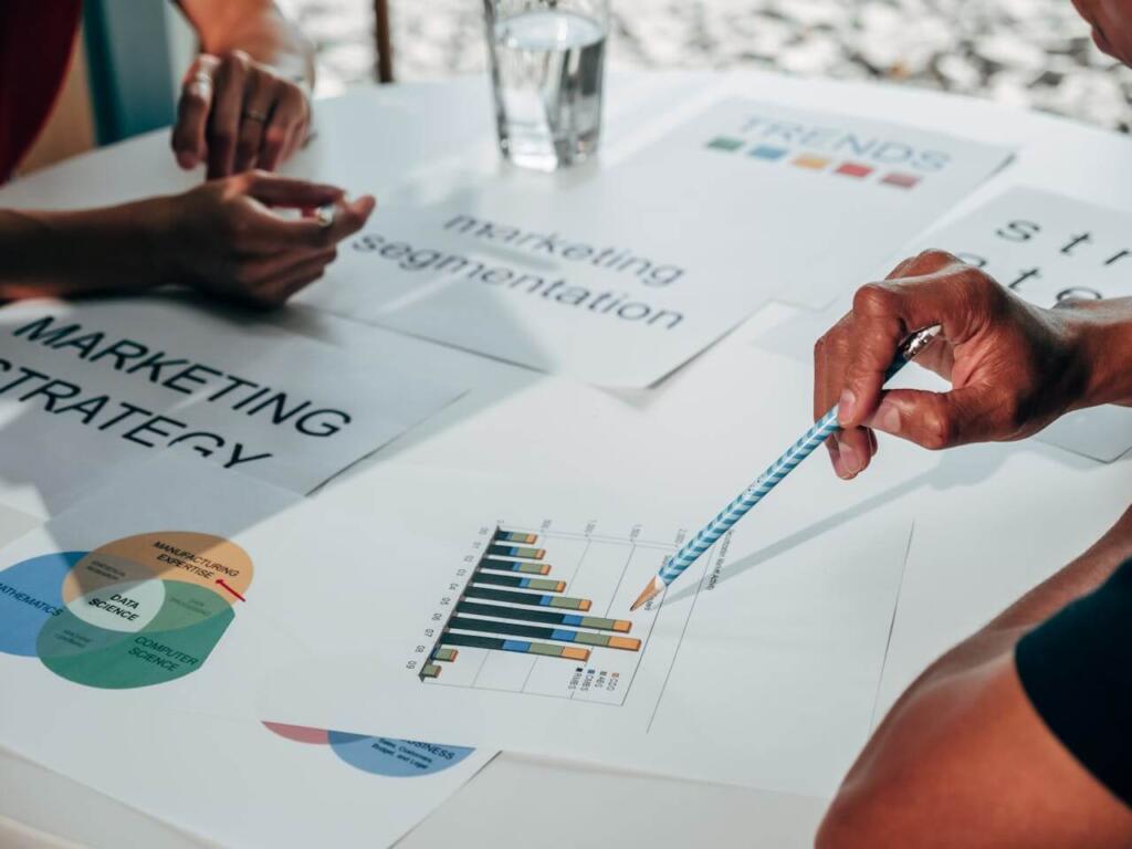 Close up of business marketing strategy print-outs, profit analysis.